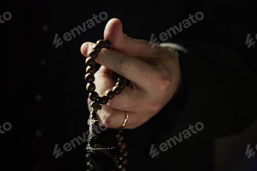 Preview: Man Praying Holding Rosary Beads Inside Church