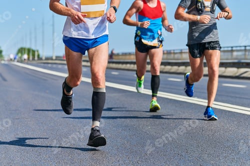 Preview: Marathon runners on city road.