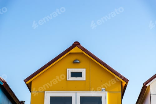 Preview: Yellow facade of a small house at the Camping De Nolle Vlissingen in the Netherlands
