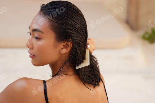 Preview: Woman Combs Wet Dark Hair Inside