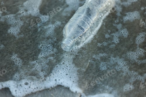Preview: Nature is our responsibilty. Shot of a bottle laying on the beach.