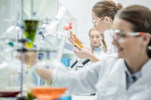 Preview: Young female scientists making experiments in chemical laboratory