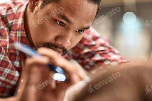 Preview: Serious professional thai barber shaving the beard