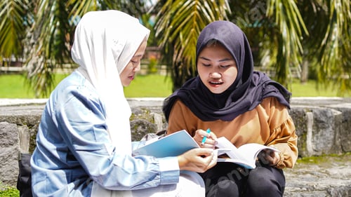 Preview: two Asian woman student friends discussing