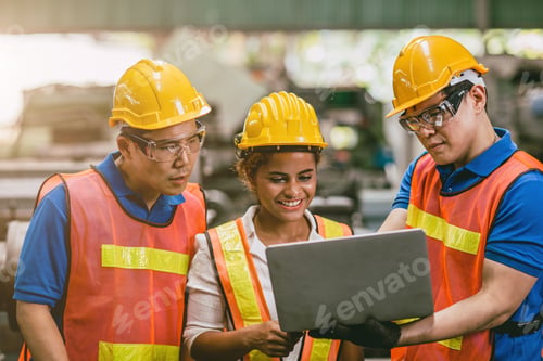 Preview: Engineer worker woman with male team working together in factory looking at Laptop computer happy