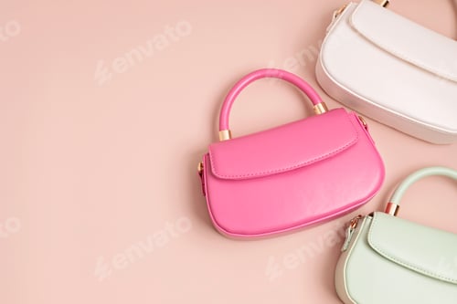 Preview: Three pastel colored womens hand bags on pink background