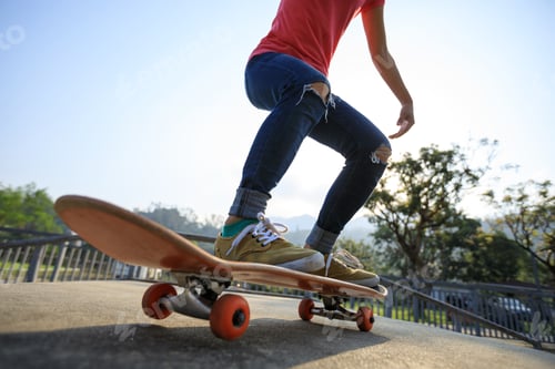 Preview: Woman skateboarder skateboarding at skatepark