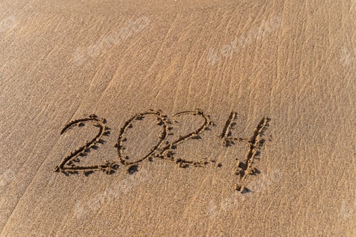 Preview: 2024 hand written in sand on a beautiful beach