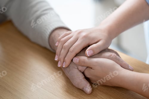 Preview: Hands of young affectionae and careful woman holding that of her senior father