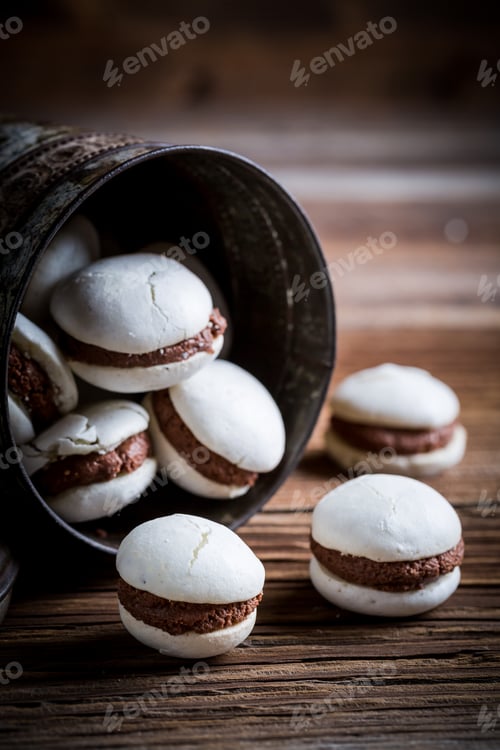 Preview: Homemade macaroons with nut filling on old wooden table