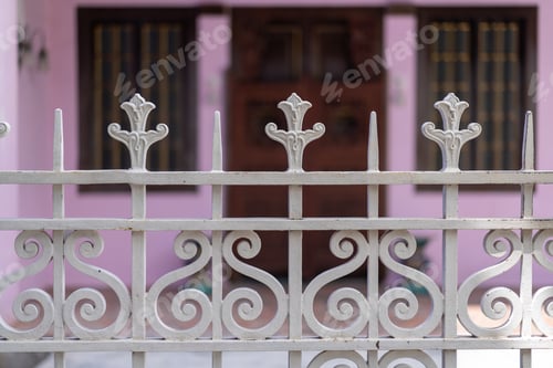 Preview: Ornate Fence in front of Pink Building Facade