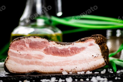 Preview: Delicious lard on a stone board with onions and spices.