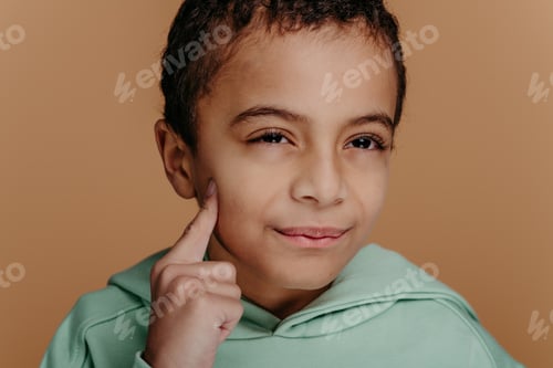 Preview: Portrait of little boy with black hair, studio shoot.