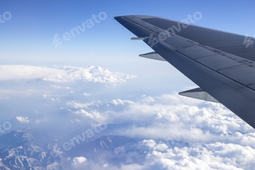 Preview: Closeup of an airplane wing flying on a beautiful cloud field