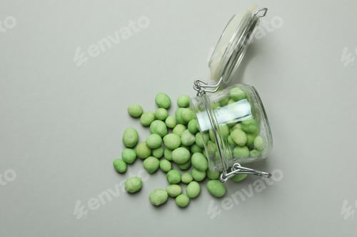 Preview: Glass jar with wasabi nuts on gray background