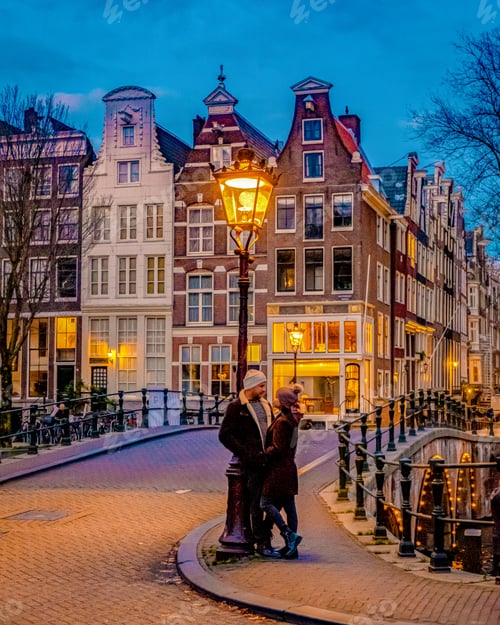 Preview: Amsterdam at night couple men and women on a city trip in Amsterdam Netherlands
