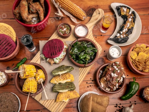 Preview: mixed colombian and venezuelan food meal spread on wooden restaurant table