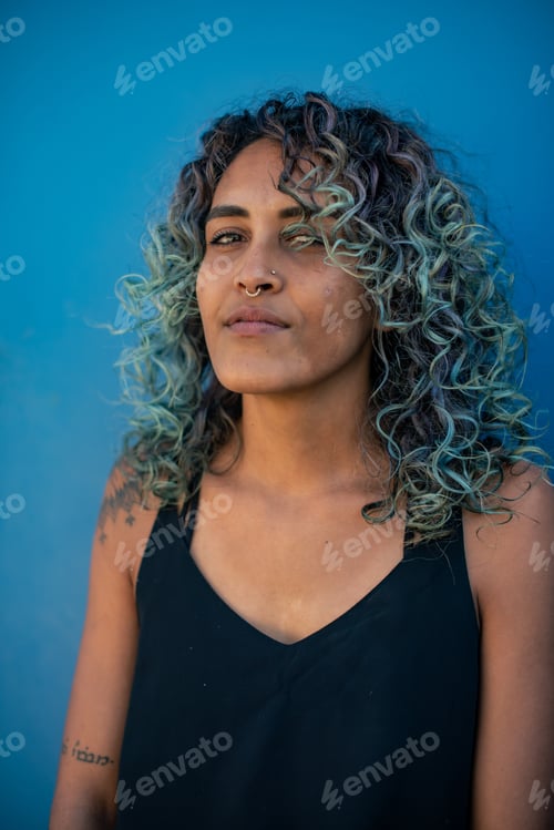 Preview: Portrait of woman with colorful hair against blue background
