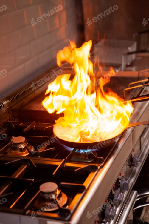 Preview: Chef cooking with high fire in kitchen