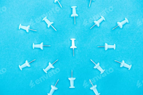 Preview: top view of white paper clip rounded by blue paper clips isolated on blue, violence concept