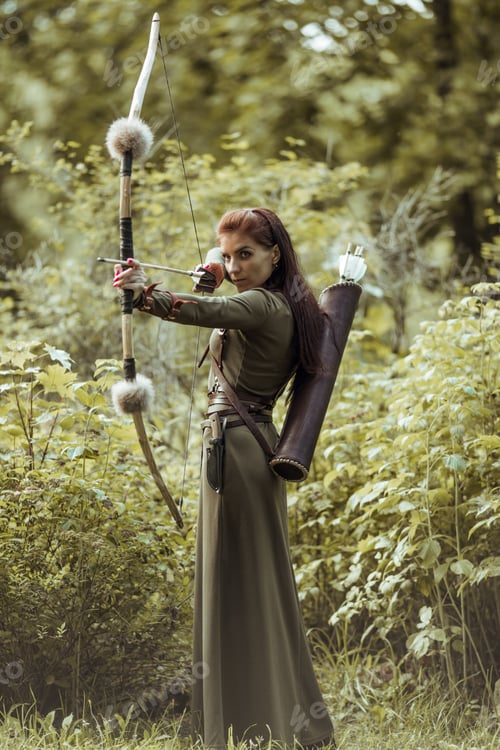 Preview: Portrait of a woman in a medieval costume. Woman warrior hunting. Hold the bow in your hands.