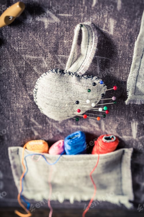 Preview: Handmade sewing mat with needles and threads in tailor workshop