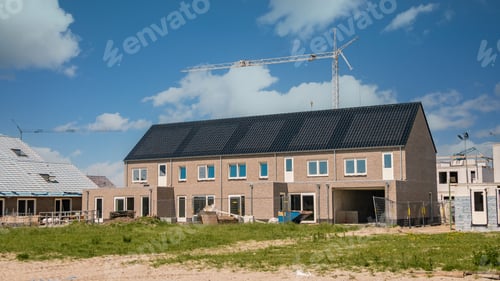 Preview: Newly build houses with solar panels attached on the roof against a sunny sky