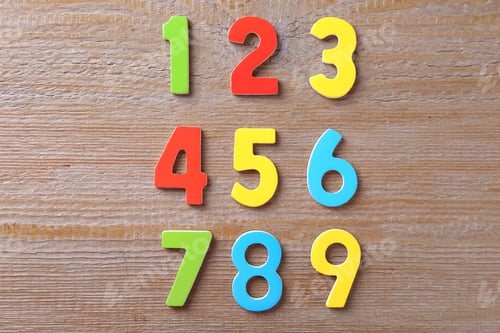 Preview: Colorful numbers on wooden table, flat lay