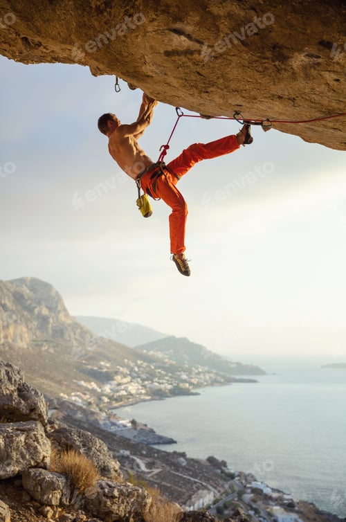 Preview: Young man climbing challenging route in cave