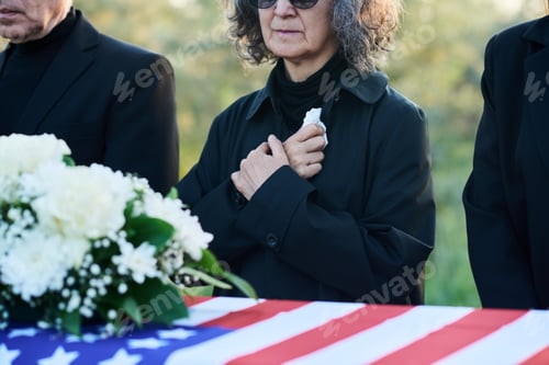 Preview: Cropped shot of mature woman with handkerchief and other people