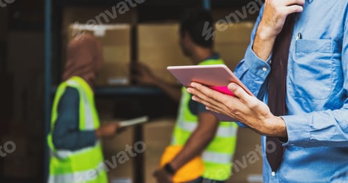 Preview: Closeup Manger hand using digital tablet over Idian worker man working with Muslim worker