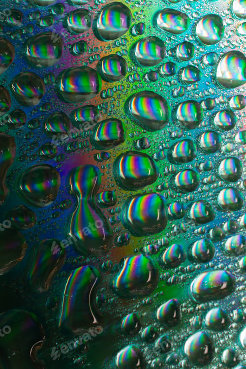 Preview: Closeup of water drops on a rainbow background