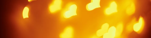 Preview: Abstract background with a golden blurred lights in heart shape. Valentine day concept