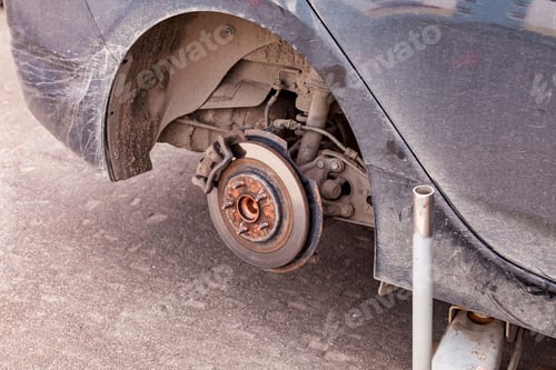 Preview: Replacing car's front chassis wheel, close-up. Front wheel of car with maintenance rust