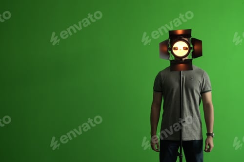 Preview: Man standing with a helmet of Game Virtual Machine and a green chroma in the background, copy space