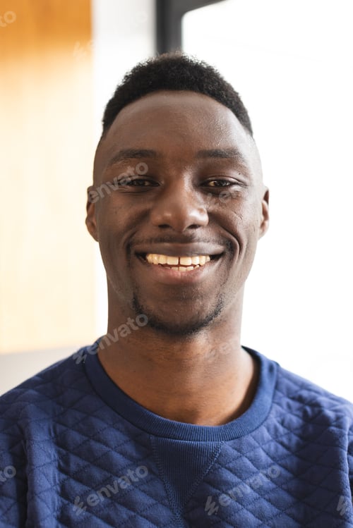 Preview: Portrait of happy african american man with short black hair smiling at home