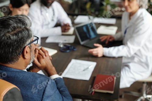 Preview: Middle Aged Caucasian Man Attending Medical Team Meeting from Top View