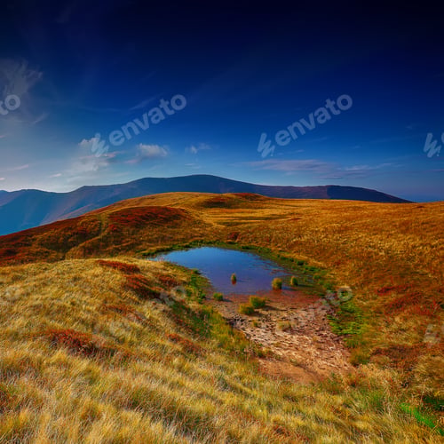 Preview: Mountain valley during bright sunrise.