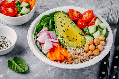 Preview: buddha bowl with quinoa, spinach, avocado, cucumbers, tomatoes, carrots, radishes, chickpeas
