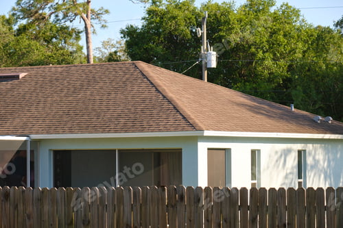 Preview: Closeup of house roof top covered with asphalt or bitumen shingles. Waterproofing of new building
