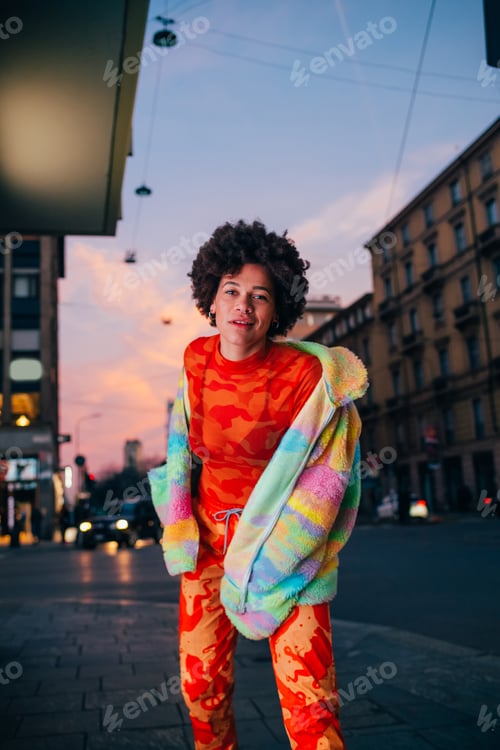 Preview: Young black woman outdoor looking over contemplative dancing in the city feeling free positive