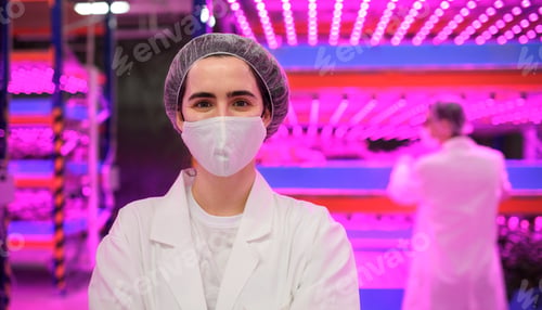 Preview: Worker with face mask on aquaponic farm, sustainable business and coronavirus