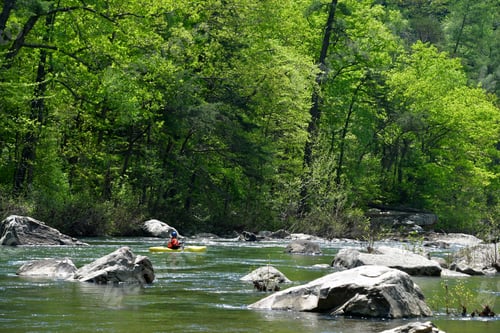Preview: Kayaker paddling down a river rapids in the mountains of Virginia.