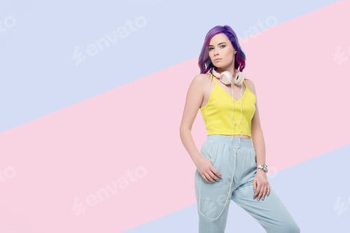Preview: young woman with headphones hanging on neck on creative background