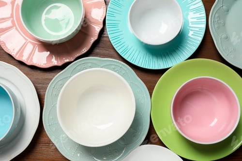 Preview: Beautiful ceramic dishware on wooden table, flat lay