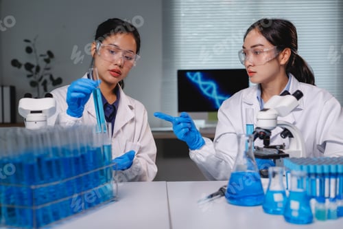 Preview: Scientists working with test tubes and beakers in laboratory