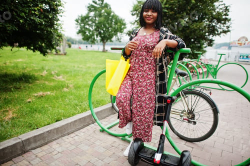 Preview: African american woman using segway or hoverboard