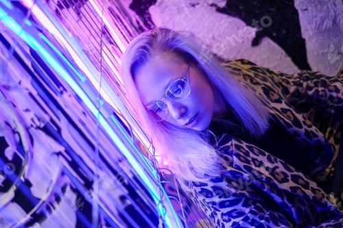 Preview: Woman face with glasses in metal frame reflect neon light