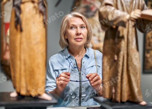 Preview: Mature Woman Visitor Looking Art Object In Art Gallery Museum