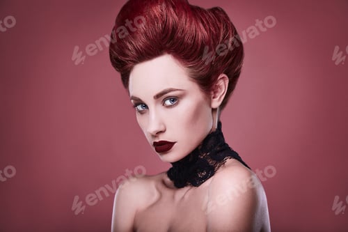 Preview: Beauty Stylish Redhead Woman With Hairstyle And Wearing Necklace Jewelry In Studio On Red Background